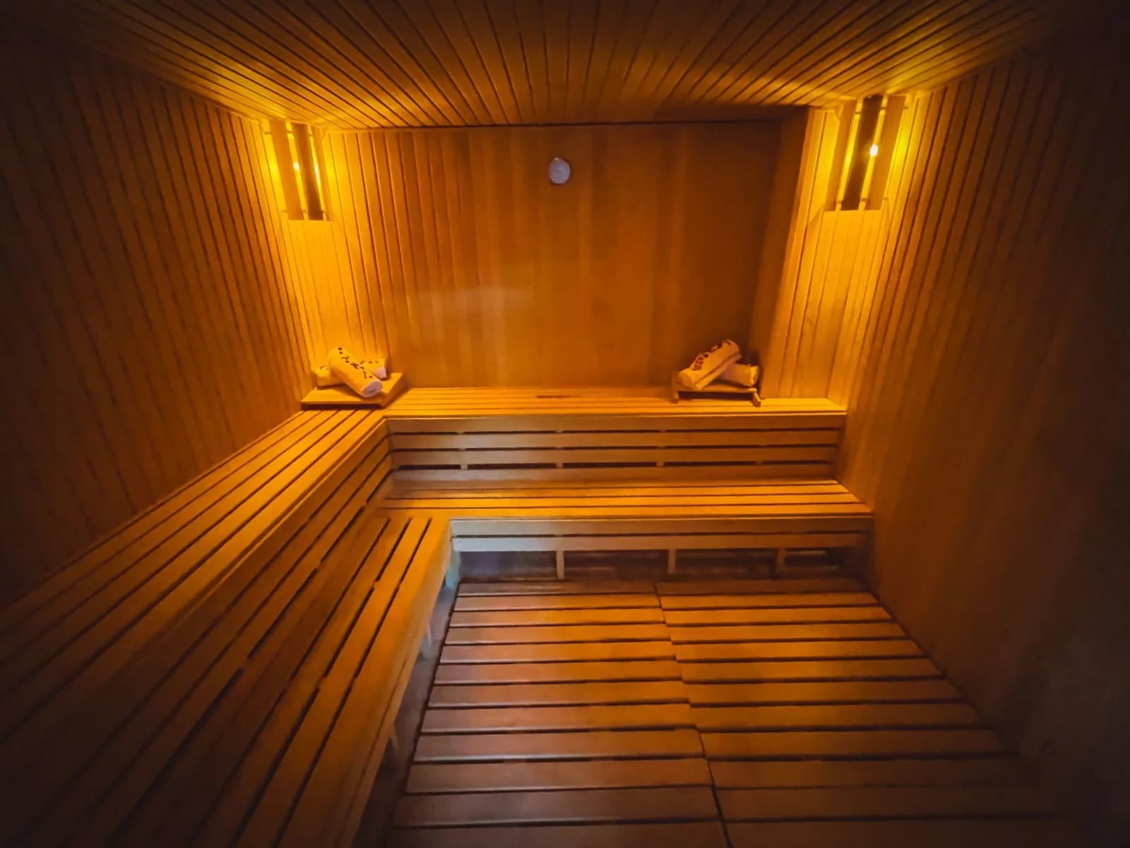 Warm dimly lit hammam steam room with soft lighting where the body acclimatises before the ritual