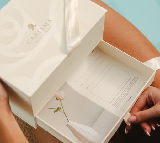 Carisma Spa corporate gift voucher box being opened, spa gift cards in Malta