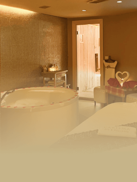 Decorated couple's massage room with candles and jacuzzi at Carisma Spa Malta