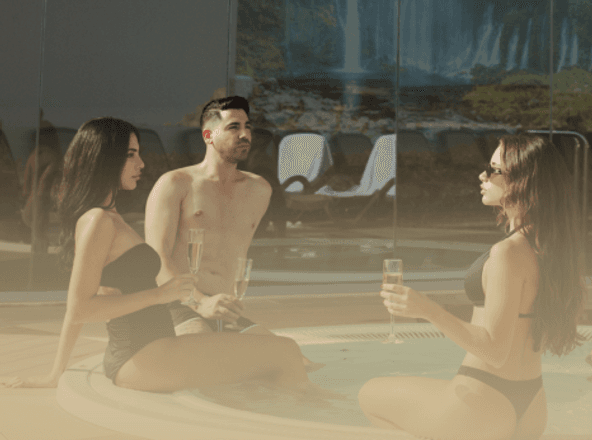 Team toasting champagne in the spa hot tub during an exclusive corporate team-building event at Carisma Spa in Malta